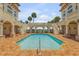 Resort-style pool with brick patio and surrounding building at 5090 Riverside Dr # 105, Port Orange, FL 32127