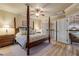 Main bedroom with king-size bed, ceiling fan, and access to a private balcony at 5090 Riverside Dr # 105, Port Orange, FL 32127
