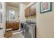 Well-appointed laundry room with washer, dryer, cabinets, and granite countertop at 5090 Riverside Dr # 105, Port Orange, FL 32127