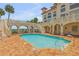 Inviting resort-style pool with brick patio and building at 5090 Riverside Dr # 105, Port Orange, FL 32127