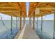 Covered boat dock with lift and waterfront views at 5090 Riverside Dr # 105, Port Orange, FL 32127