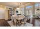 Open concept dining area with hardwood floors and adjacent living room at 5090 Riverside Dr # 105, Port Orange, FL 32127