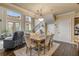Bright dining area with hardwood floors and a view into the living room at 5090 Riverside Dr # 105, Port Orange, FL 32127