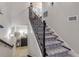 View of a staircase with patterned carpet runner and wrought iron railing at 5090 Riverside Dr # 105, Port Orange, FL 32127