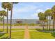 Brick walkway to waterfront with palm trees and boat docks at 5090 Riverside Dr # 105, Port Orange, FL 32127