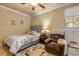 Cozy bedroom featuring a bed, chair, and nightstand at 5090 Riverside Dr # 105, Port Orange, FL 32127