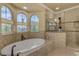 Spa-like bathroom with a walk-in shower, soaking tub, and large windows at 5090 Riverside Dr # 105, Port Orange, FL 32127