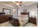 Spacious bedroom with a ceiling fan, dresser, and comfortable bed at 5090 Riverside Dr # 105, Port Orange, FL 32127