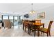 Dining room with wooden table and chairs, offering a view to the ocean at 5301 S Atlantic Ave # 630, New Smyrna Beach, FL 32169