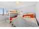 Bedroom with full-size bed and a bunk bed, bright and airy at 5301 S Atlantic Ave # 630, New Smyrna Beach, FL 32169