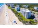 Aerial view of beachfront condo building, pool, and parking area at 5301 S Atlantic Ave # 630, New Smyrna Beach, FL 32169