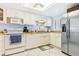 Kitchen with white cabinets, stainless steel appliances, and wood countertops at 5301 S Atlantic Ave # 630, New Smyrna Beach, FL 32169
