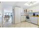 Bright kitchen features white cabinets, tile floors, and a view into the living area at 5301 S Atlantic Ave # 630, New Smyrna Beach, FL 32169