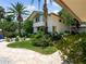 Landscaped front yard with a curved walkway and lush greenery at 1006 S Riverside Dr, Edgewater, FL 32132