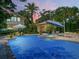 Inviting pool area with spa, patio furniture, and a fire pit at 1006 S Riverside Dr, Edgewater, FL 32132