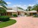 Elegant home featuring a metal roof and brick driveway at 1006 S Riverside Dr, Edgewater, FL 32132