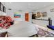 Spacious primary bedroom with a king-size bed and artistic wall decor at 1006 S Riverside Dr, Edgewater, FL 32132