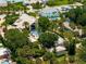 Aerial view of waterfront property with pool and lush landscaping at 1006 S Riverside Dr, Edgewater, FL 32132