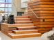 Contemporary floating staircase with wood and glass at 1006 S Riverside Dr, Edgewater, FL 32132