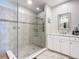 Spa-like bathroom with a large walk-in shower, modern vanity, and marble countertops at 807 S Atlantic Ave # 302, New Smyrna Beach, FL 32169
