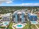 Aerial view of a coastal condo building with multiple pools and ocean views at 807 S Atlantic Ave # 302, New Smyrna Beach, FL 32169