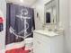 Small bathroom with an anchor-themed shower curtain at 807 S Atlantic Ave # 302, New Smyrna Beach, FL 32169