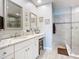 Elegant bathroom featuring a walk-in shower and a double vanity at 807 S Atlantic Ave # 302, New Smyrna Beach, FL 32169
