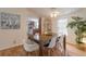 Dining room with wooden table, white chairs, and hardwood floors at 4391 Maple Ave, Edgewater, FL 32141