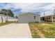 Gray house with concrete driveway and small yard at 4391 Maple Ave, Edgewater, FL 32141