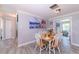 Bright dining area with white table and chairs near hallway at 632 Goodwin Ave, New Smyrna Beach, FL 32169