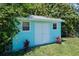 Light blue storage shed with white double doors at 632 Goodwin Ave, New Smyrna Beach, FL 32169