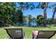 Relaxing backyard oasis with lounge chairs overlooking a canal at 632 Goodwin Ave, New Smyrna Beach, FL 32169