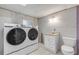 Simple bathroom with white vanity, toilet, and washer/dryer at 801 E 24Th Ave, New Smyrna Beach, FL 32169