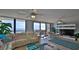 Living room with ocean view, comfy seating, and large TV at 4139 S Atlantic Ave # B204, New Smyrna Beach, FL 32169