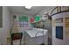 Laundry room with washer, dryer, and shelving for storage at 4139 S Atlantic Ave # B204, New Smyrna Beach, FL 32169