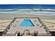 Aerial view of refreshing pool with plenty of lounge chairs at 4139 S Atlantic Ave # B204, New Smyrna Beach, FL 32169