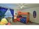Bright bedroom with a bunk bed, nightstand, and beach-themed decor at 4139 S Atlantic Ave # B204, New Smyrna Beach, FL 32169