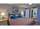 Comfortable bedroom with ensuite bathroom and decorative pillows at 4139 S Atlantic Ave # B204, New Smyrna Beach, FL 32169
