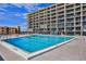 Community pool with plenty of surrounding lounge chairs at 4139 S Atlantic Ave # B204, New Smyrna Beach, FL 32169