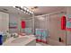 Clean bathroom with flamingo-themed towels and a shower/tub combo at 4139 S Atlantic Ave # B204, New Smyrna Beach, FL 32169
