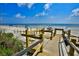Wooden boardwalk leads to sandy beach at 4139 S Atlantic Ave # B204, New Smyrna Beach, FL 32169