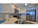 Updated kitchen featuring stainless steel appliances and white cabinets at 4139 S Atlantic Ave # B204, New Smyrna Beach, FL 32169