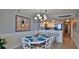 Bright dining area with white table and chairs, adjacent to kitchen at 4139 S Atlantic Ave # B204, New Smyrna Beach, FL 32169