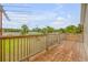 Wooden deck overlooking backyard with treetop views at 299 W Hickory Ave, Oak Hill, FL 32759