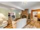 Living room with a brick fireplace, hardwood floors, and comfortable seating at 299 W Hickory Ave, Oak Hill, FL 32759