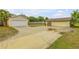 Two-car garage with a large driveway at 299 W Hickory Ave, Oak Hill, FL 32759