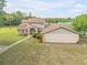 Two story home with a pool and detached garage at 299 W Hickory Ave, Oak Hill, FL 32759