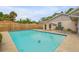 Sparkling, rectangular pool with a concrete deck and wooden fence at 299 W Hickory Ave, Oak Hill, FL 32759