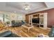 Spacious living room with hardwood floors, a media center, and comfortable seating at 299 W Hickory Ave, Oak Hill, FL 32759