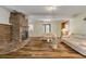 Living room with a brick fireplace and hardwood floors at 299 W Hickory Ave, Oak Hill, FL 32759